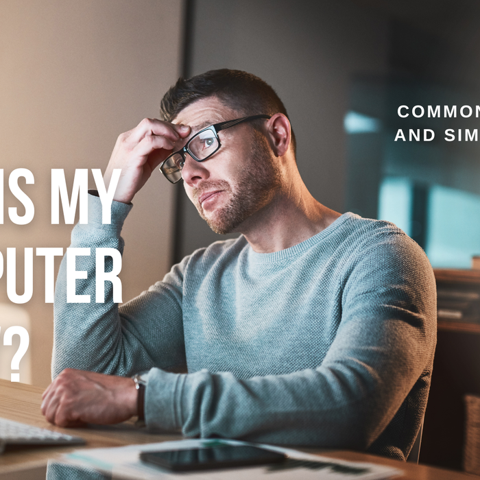 man next to slow computer upset and looking for fixes to problems